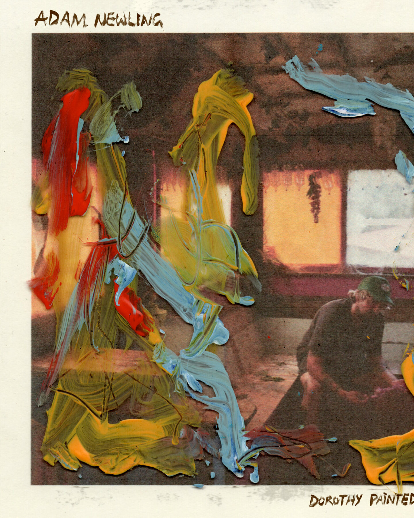 An album cove featuring blue, red and yellow streaks of paint over the top of a hazy image of a man sitting alone in a sparse room