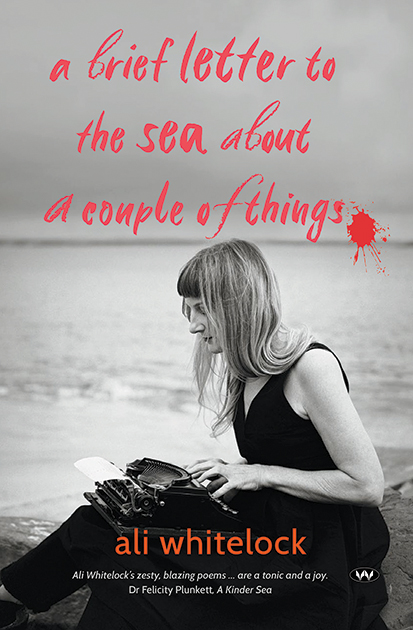 A book cover featuring a grayscale image of a young woman with a typewriter on her lap sitting in front of a beach. The title of the book is in red at the top of the image