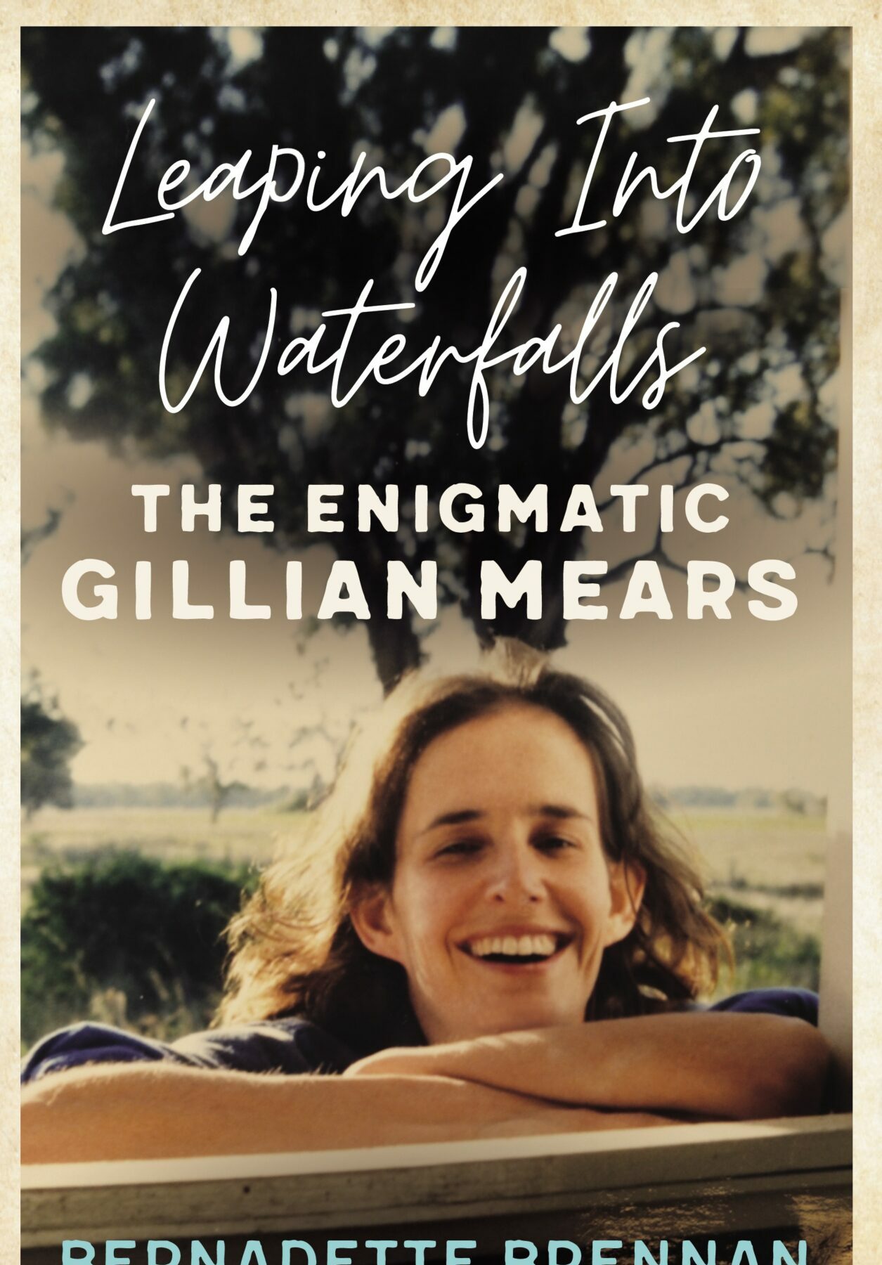 A book cover featuring a young woman leaning on a railing and laughing with a tree in the background, and the title in white script font above her