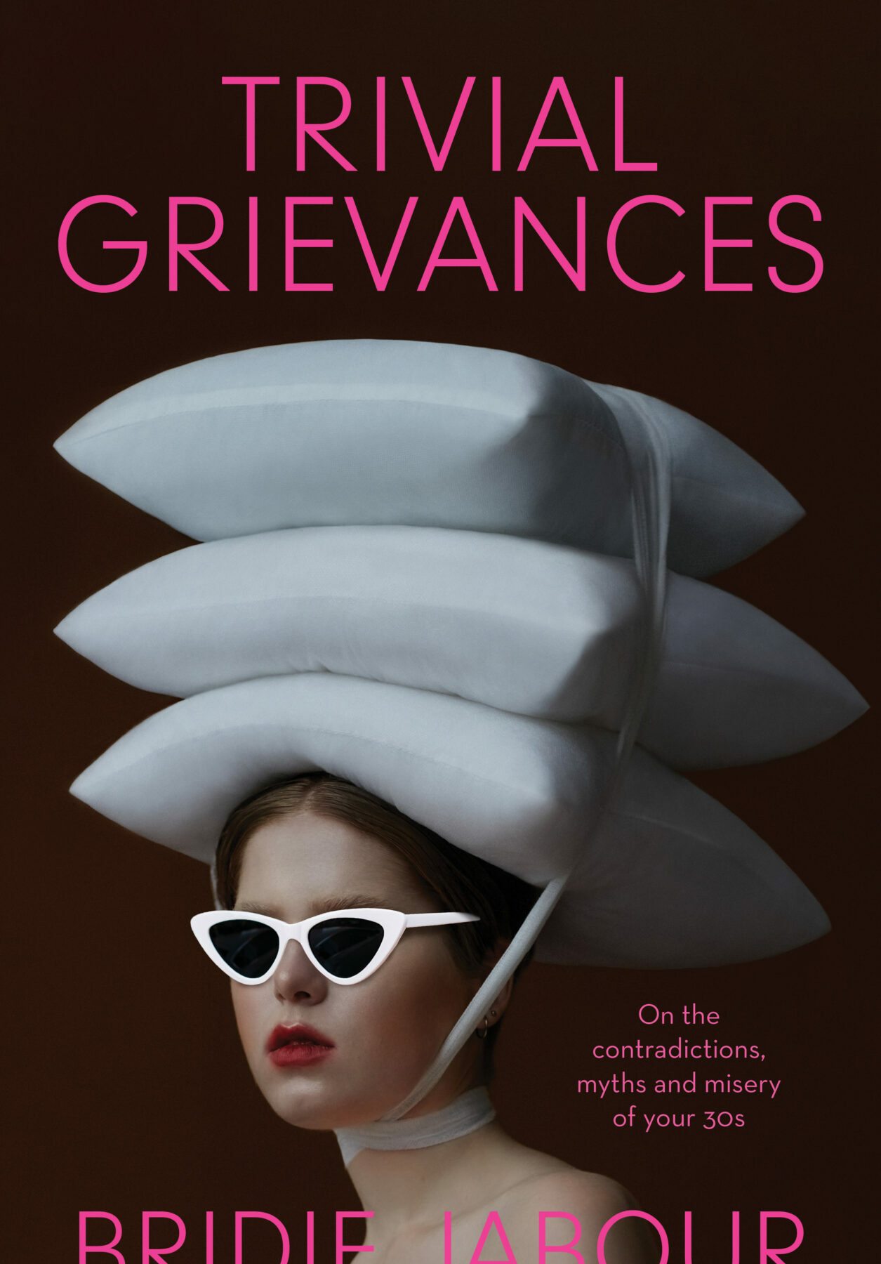 A book cover featuring a photograph of a young woman with white sunglasses and three white pillows tied to the top of her head.