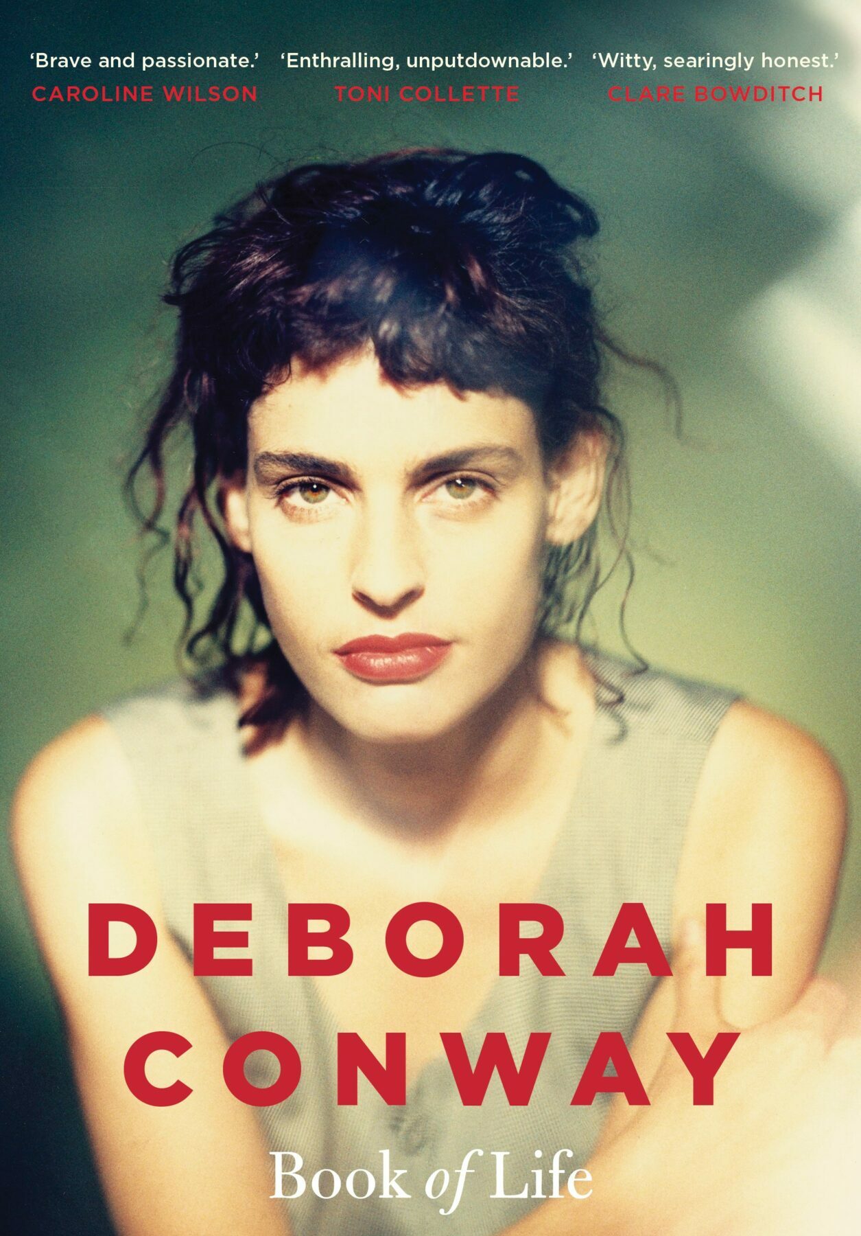 A book cover featuring a woman with black hair in a messy bun, leaning forward and looking serious, with the authors name in red block letters and the title in white underneath